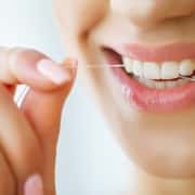 dental-care-woman-with-beautiful-smile-using-floss-teeth-image