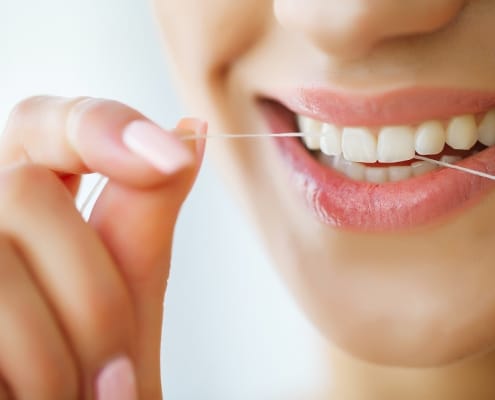 dental-care-woman-with-beautiful-smile-using-floss-teeth-image